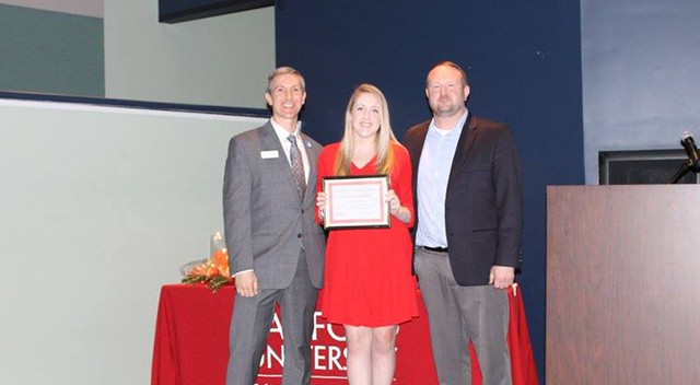 Jodie McKaughan (center) was named an oustanding graduate student