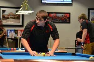Radford University Billiards Club members Jessie Fitzgerald (center) and Brad Egener (left) compete in the March 24-25 pool tournament, hosted by the university, on March 