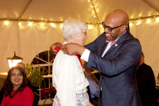 President Brian O. Hemphill, Ph.D., inducts a member of the Class of 1967 with a medal in honor of her alma mater.